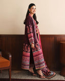 Side view of deep purple printed raw silk suit with pink embroidered dupatta draped over shoulder