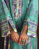 Close-up of embroidered sleeve cuffs and hands on green printed raw silk suit