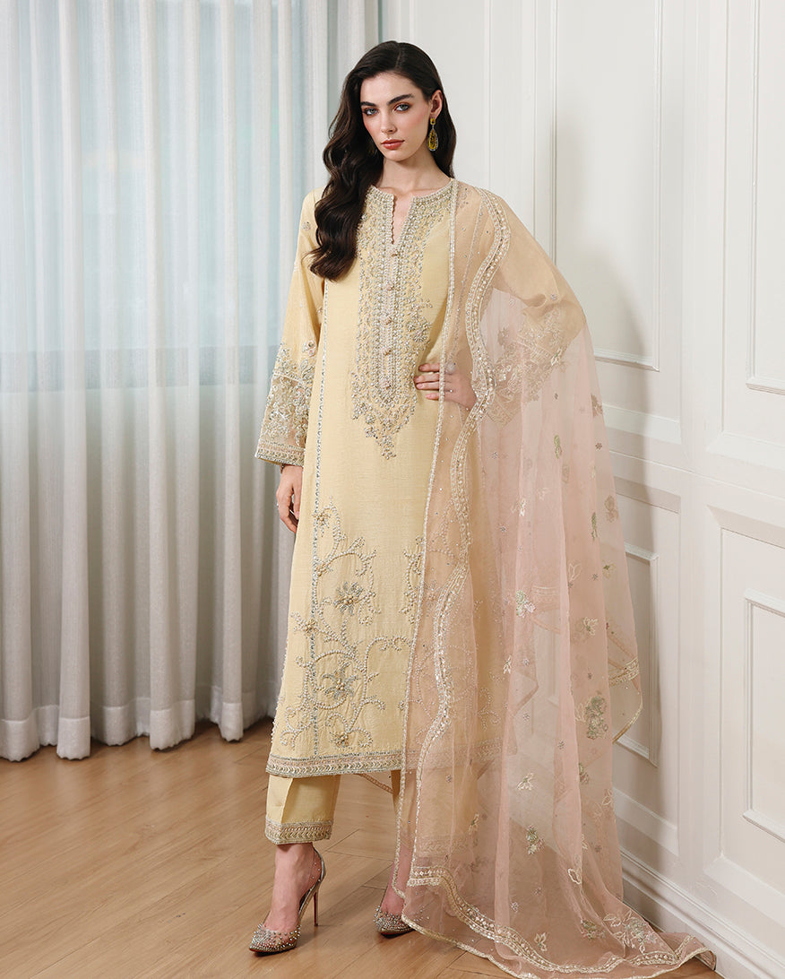 Woman wearing lemon yellow Korean raw silk mid-length shirt with straight trouser and organza dupatta
