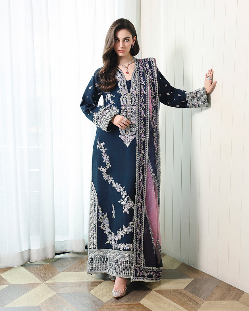 Woman wearing blue Korean raw silk suit with dyed organza dupatta draped over shoulder