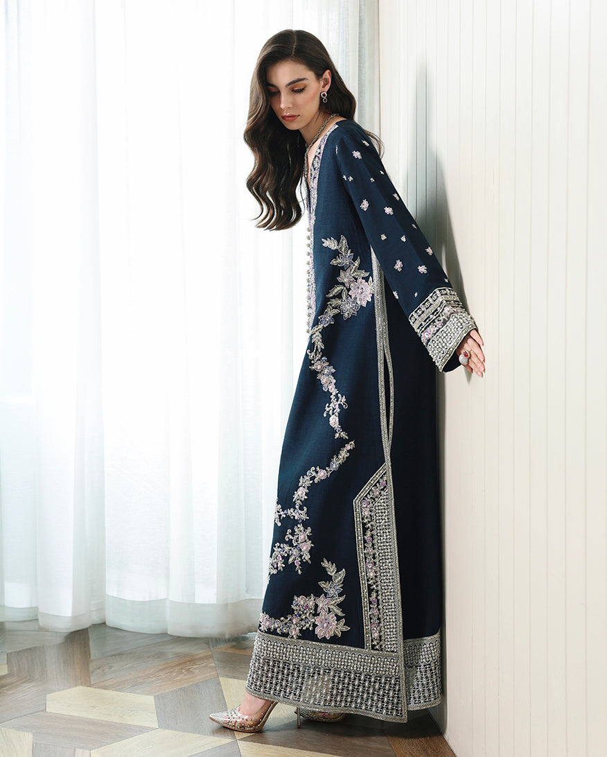 Side view of blue Korean raw silk shirt with wide sleeves and sweeping silhouette