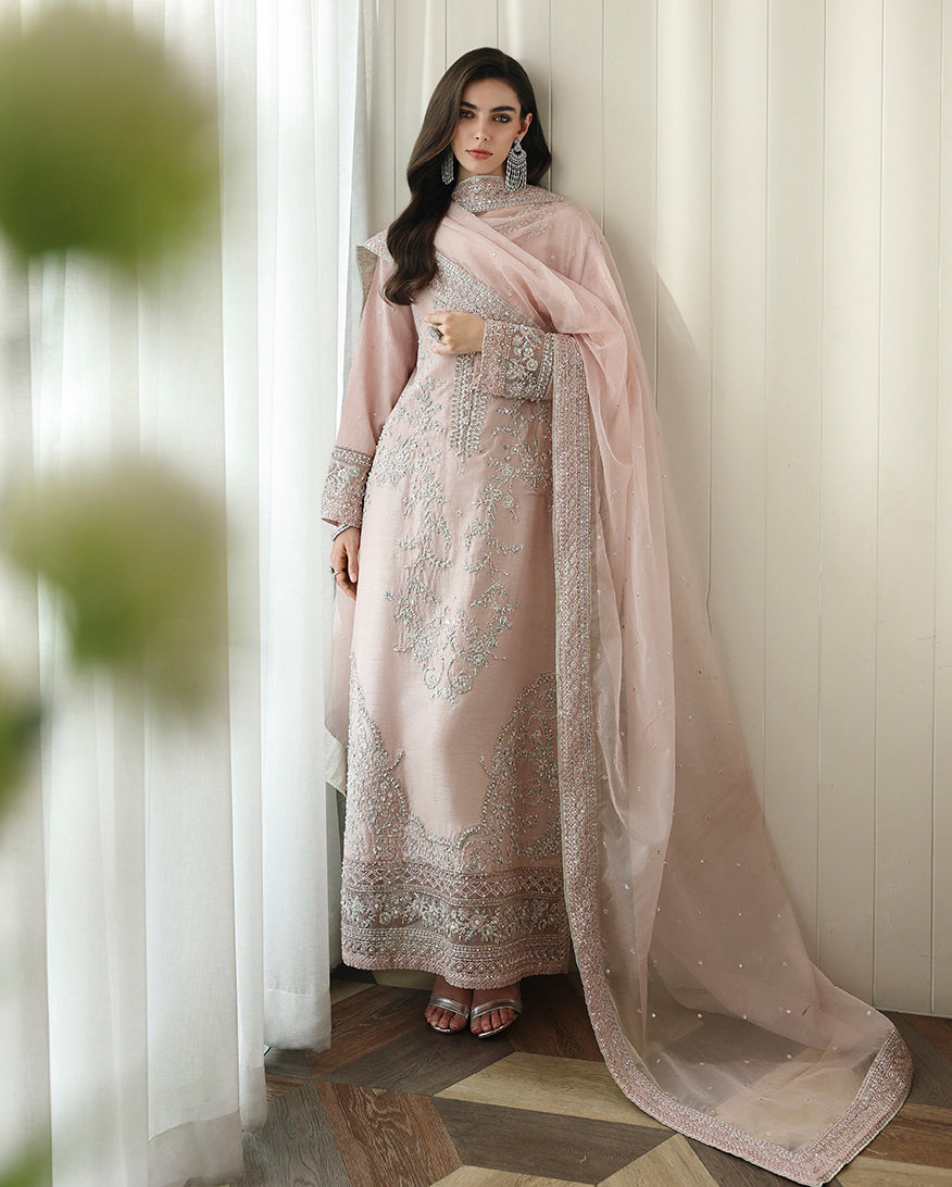 Woman wearing nude pink Korean raw silk shirt with embroidered hem and long draped organza dupatta