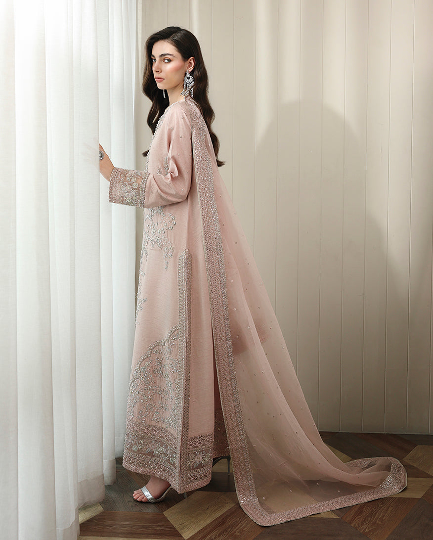 Side view of nude pink Korean raw silk shirt with flowing hemline and long organza dupatta trailing behind