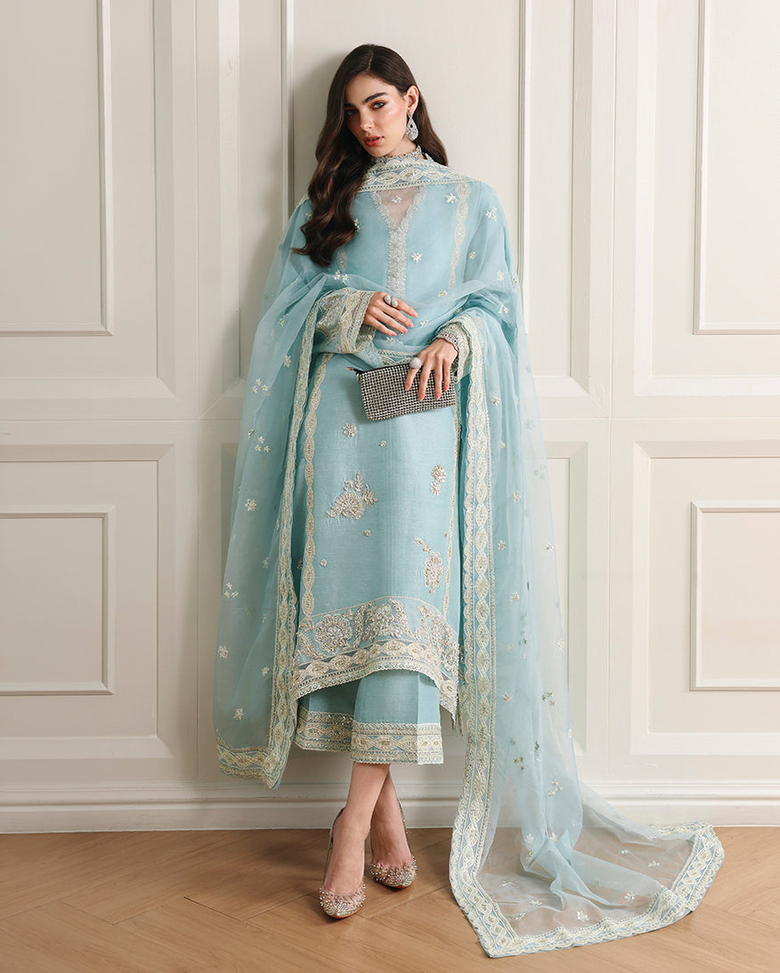 Woman wearing sky blue Korean raw silk shirt with matching trouser and embroidered border organza dupatta
