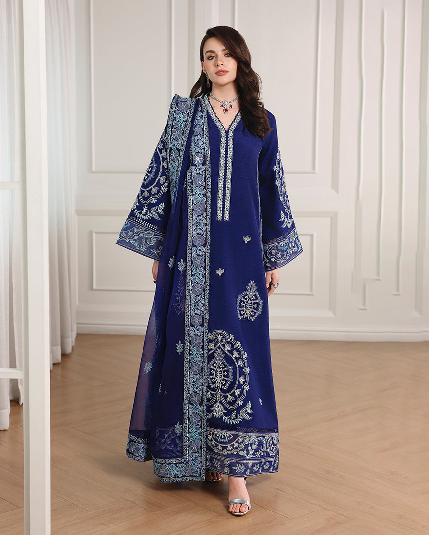 Woman wearing royal blue Korean raw silk suit with embroidered long shirt and organza dupatta over shoulder