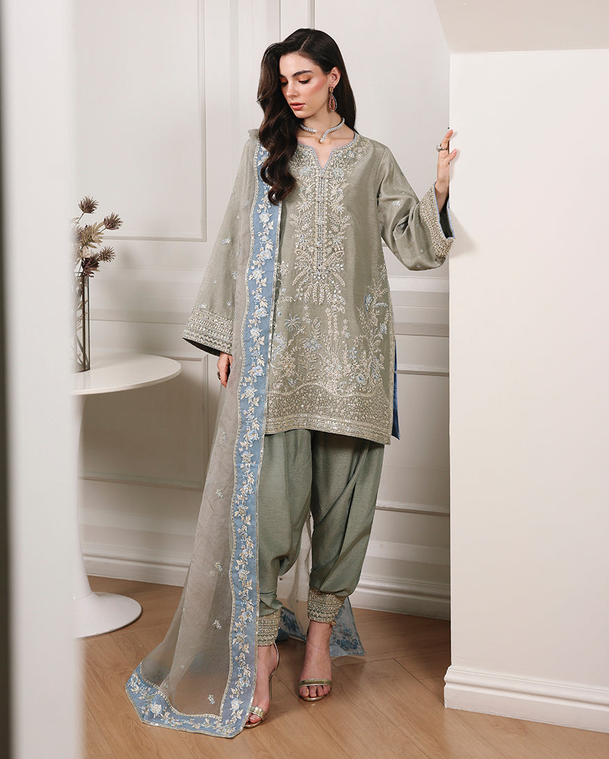Woman wearing gray green Korean raw silk kurta-length shirt with shalwar and embroidered organza dupatta