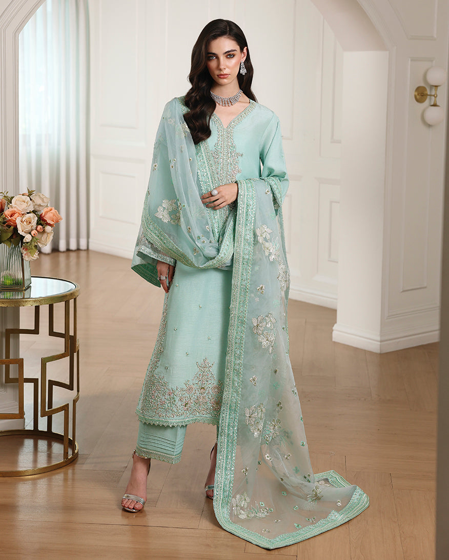 Woman wearing blue Korean raw silk suit with embroidered neckline, straight trouser and organza dupatta