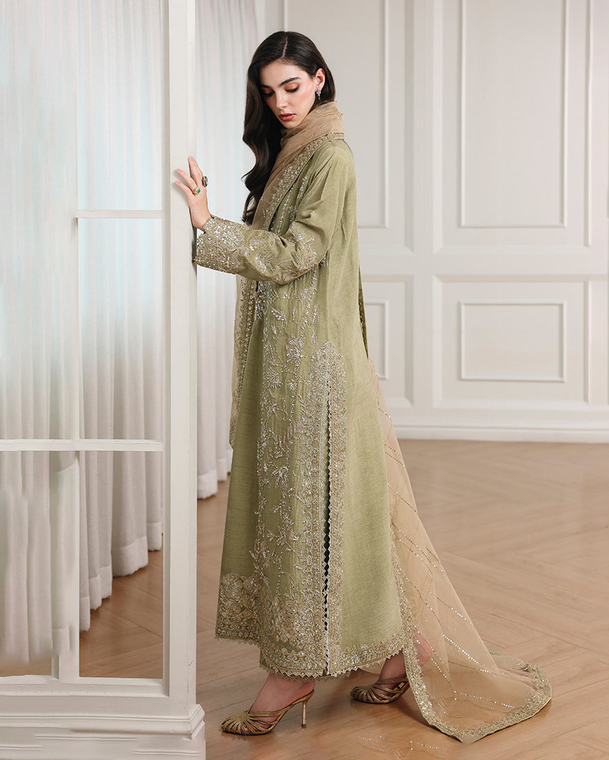 Side view of olive green Korean raw silk shirt with embroidered hem and organza dupatta trailing behind